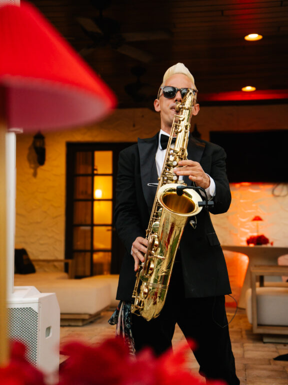 Live trio band performing during a birthday celebration.